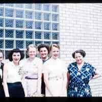 Color slide of a group of women in front of a building.