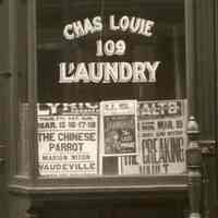          detail center: posters in Chas. Louie Laundry window
   