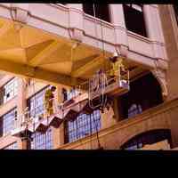 Color slide of painters working on a K & E building.