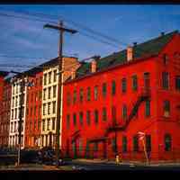 Color slide of eye-level view of industrial building façade with fire escape at 55 Bloomfield and adjacent four row houses along Bloomfield on the NE corner of Bloomfield and Observer Highway