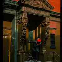          Color slide of close-up view of bracketed portico, pediment and frieze reading 