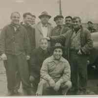 B+W group photo of "On the Waterfront" filming in Hoboken: group of ten men near vehicles, Hoboken, no date, ca. late 1953-early 1954.