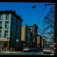 Color slide of eye-level view of row houses on the S side of 6th looking W from the NE corner with Garden