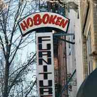 Color photo of hanging sign for Hoboken Furniture, 157 First Street, Hoboken, Jan. 3 & 4, 2002.