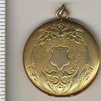 Locket with two photos, owner unknown as well as photo subjects.