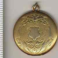 Locket with two photos, owner unknown as well as photo subjects.