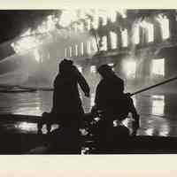 B+W photo of Hoboken firefighters manning hose at railroad yard fire, Observer Highway, Hoboken, n.d, ca. 1983-1988.