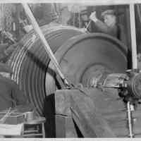 B+W photo of 4 workers repairing vanes on a turbine rotor, Hoboken, no date, ca. 1935-1940.