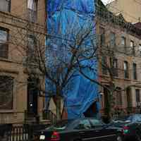 Color photos, 2, of a residential building with tarpaulin covered scaffold; plus a truck, Hoboken, March 19, 2006.17, of Patterson Plank Rd. building exterior walls reinforced for re-use in new building, Jersey City, May 20, 2006.