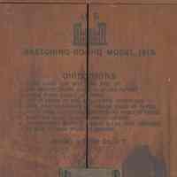          detail back, center top: compass, text and mounting plate
   