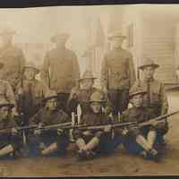 Digital image of photo of a military unit posed with rifles outside a military barracks or other base building, no place, no date, circa 1900-1910.