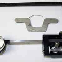          planimeter:fixed arm; test rule; tracing arm with measure (bottom view)
   