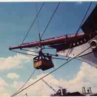          07 man in work basket suspended by crane at bowsprit
   