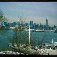          Color slide of eye-level view from the Stevens Institute campus of the SS Stevens docked at Castle Point with the New York City skyline including the Empire State Building across the Hudson River picture number 1
   