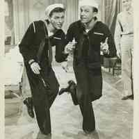 Sepia-tone photo, movie still, of Frank Sinatra & Gene Kelly in film "Anchors Aweigh", no place, 1945.