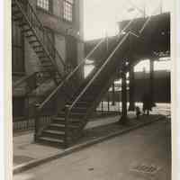 Sepia tone photo of the northeast corner of Willow Ave. at Ferry St. with stairs to elevated streetcar station, Hoboken, n.d., ca. 1932-1938.