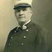 Photo postcard portrait of Battalion Chief Michael J. Kennedy, Hoboken Fire Department, Hoboken, 1921.