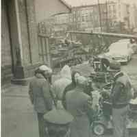 Black-and-white candid photo of "On the Waterfront" filming in Hoboken: preparation/rehearsal for a scene, Hoboken, no date, ca. late 1953-early 1954.