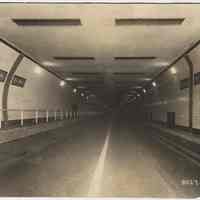 B+W photo inside north tube, Holland Tunnel at state line markers, Feb. 28, 1928.