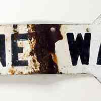 Painted metal horizontal arrow sign "One Way," ca. 1930s.