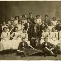 Sepia-tone group photo of 8th grade graduation class of School No. 8; Rose Beck seated at right, Hoboken, n.d., ca. 1910.