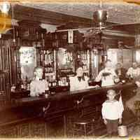 Digital image of sepia-tone photo of a New York City bar interior with John Muller standing behind bar at the left, New York, no date, ca. 1903-1905.