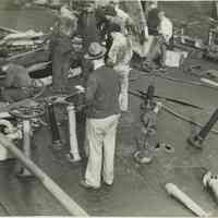 B+W photo showing workers inspecting damage on the main deck on unidentified vessel at the Bethlehem Steel Shipyard, Hoboken Division, no date, ca. 19