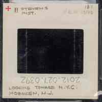          Color slide of eye-level view from the Stevens Institute campus of the SS Stevens docked at Castle Point with the New York City skyline including the Empire State Building across the Hudson River picture number 2
   