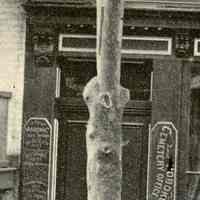          detail 4, left: door to upper floors with signs
   