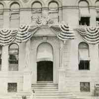 B+W photo of Free Public Library, lower facade 5th St. side, with bunting, Hoboken, n.d., circa 1912-1920.