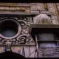          Color slide of detail view of portico keystone, oculi window, pilasters, and capitals of Public School No. 7 building at 80 Park on the SW corner with Newark picture number 1
   