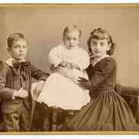 Cabinet photo of a girl, boy & baby (related to Great-Grandmother Lancy) posed in photographer