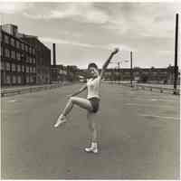 B+W photo of a girl practicing with a baton in a parking lot, Hoboken, no date, [1976].