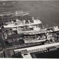 B+W aerial photo of USS Compass Island, USNS Vanguard & other ships at Bethlehem Steel Hoboken Shipyard, n.d., ca. 1969.