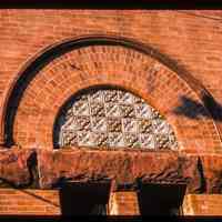 Color slide of close-up view of brickwork, gauged arch and decorative tiles on the façade of the First Baptist Church at 901 Bloomfield on the corner of Bloomfield and 9th