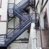          54: detail upper portion of emergency stairs, central portion, west facade
   