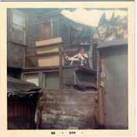 Color photo of a man on a rear deck of a Willow Terrace house, Hoboken, August 1966.