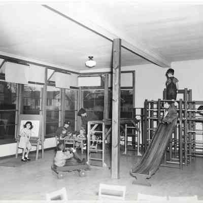Children playing on indoor playground equipment