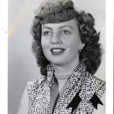 Protrait of Queen Audrey Moe wearing a spotted short-sleeve top with tippon on her left shoulder