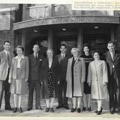Adminitration H. Fotheringill, Mrs. Mann, A. G. Hudtloff, Mrs. Tate, C. Aden, Mrs. Payne, Miss Wilmarth, Mrs. Staffelbach, and D. Mortensen standing in front of Clover Park Senior High School