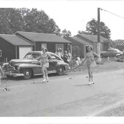 Three baton twirlers and majorette walking, possibly in Parkland Round Up Parade