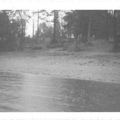 View of American Lake South Park Beach from the water, possibly on a rainy afternoon
