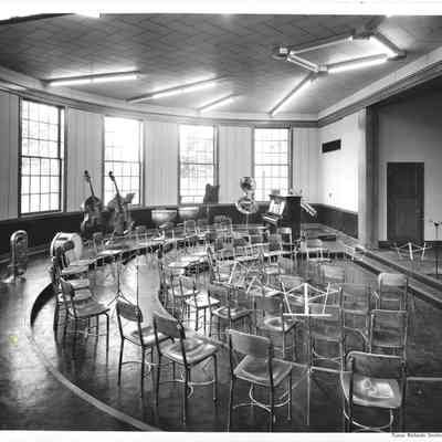 Music room with empty chairs setup in front of large windows