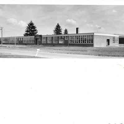 Wideshot of the new Lakeview Elementary School edition with unfinished courtyard and part of paved road plane in background