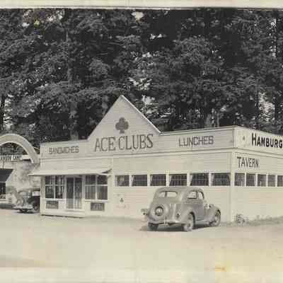 Car parked in front of Ace Clubs Tavern