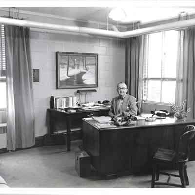 H. G. Hudtloff sitting proudly at desk in his office in Clover Park Jr. - Sr. High School