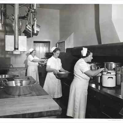 Ruby Robertson, Margaret Newman, and Edith Ambrose play at working in kitchen, carrying or stirring pots