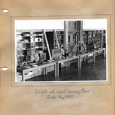 Exhibit of wood carving class with all pieces set out on tables 1942