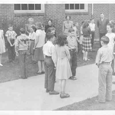 Children standing in squares outside of school