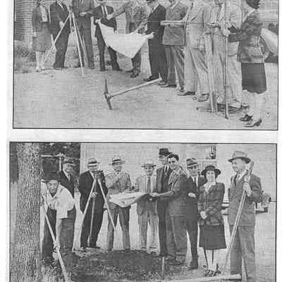 Several people with a tarp hanging from a wire connected to a tripod with pickaxes and shovels